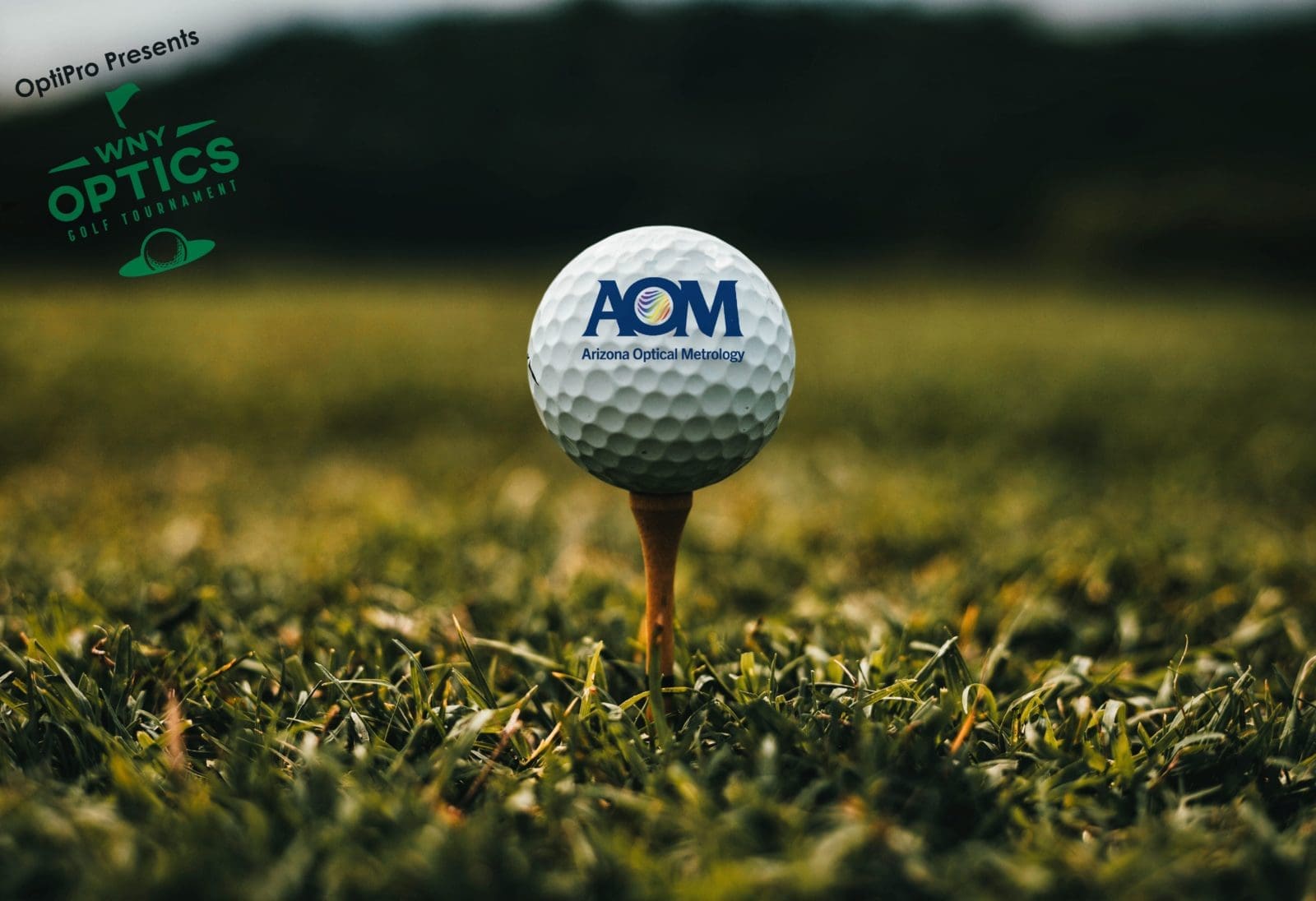 AOM on Golf Ball 1.2 A close up of a golf ball with the AOM logo sitting on a tee