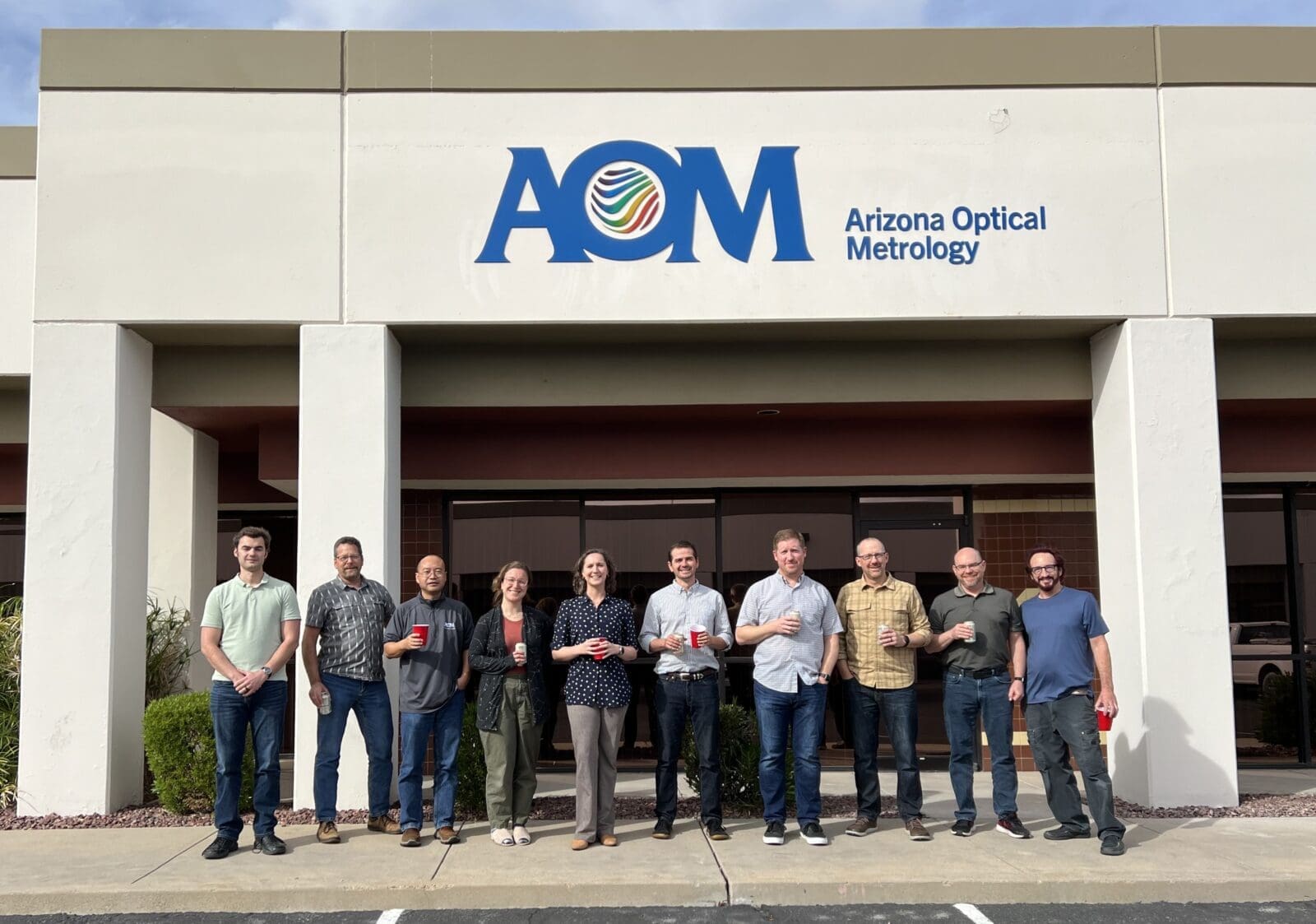 Meet the AOM Team! The AOM team poses in front of the Tucson office.
